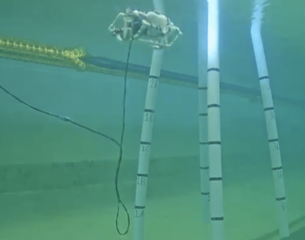 An ROV with its camera pointing at one of four columns.