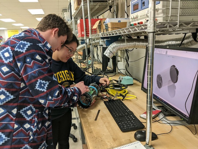 a student getting help from an IA about their 3D model of the ROV payload